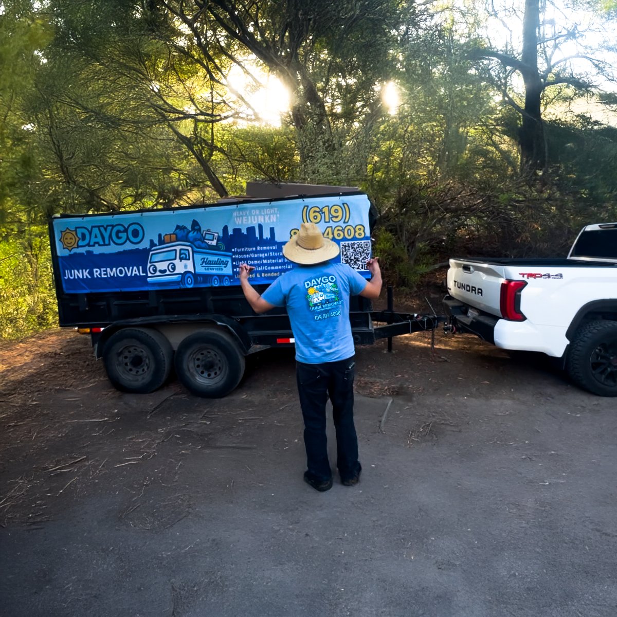 Daygo Junk Removal crew and trailer on a job site